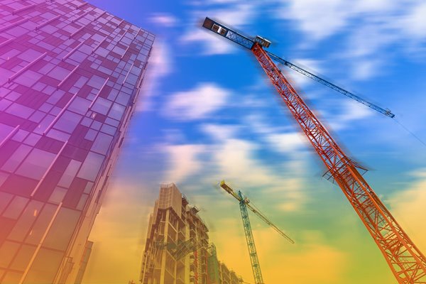 Skyscraper under construction with a crane.