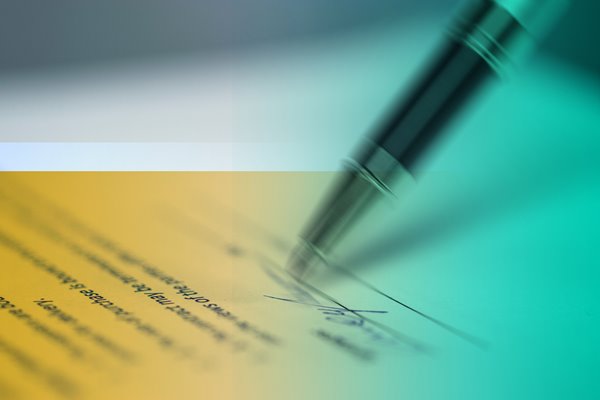A pen signing a contract.