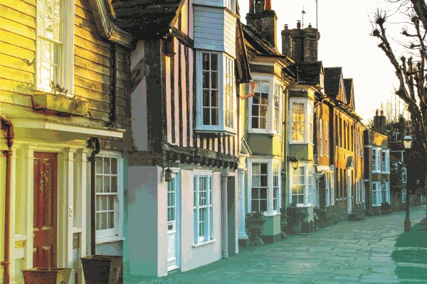 Horsham street with multi-coloured buildings at sunset.