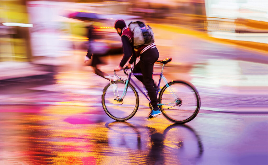 Cyclist riding a bike on a street.