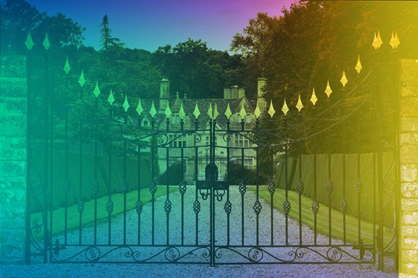 Elegant gates leading to large house.
