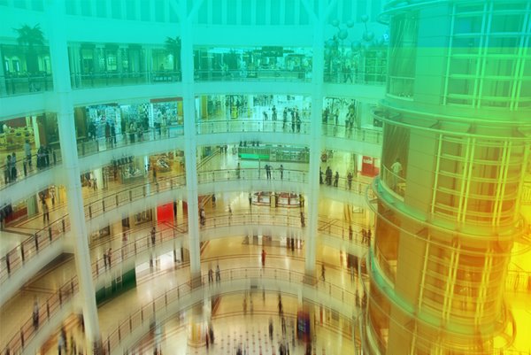 Busy shopping centre with various stores.
