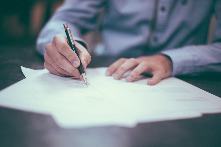 A person writing on paper.