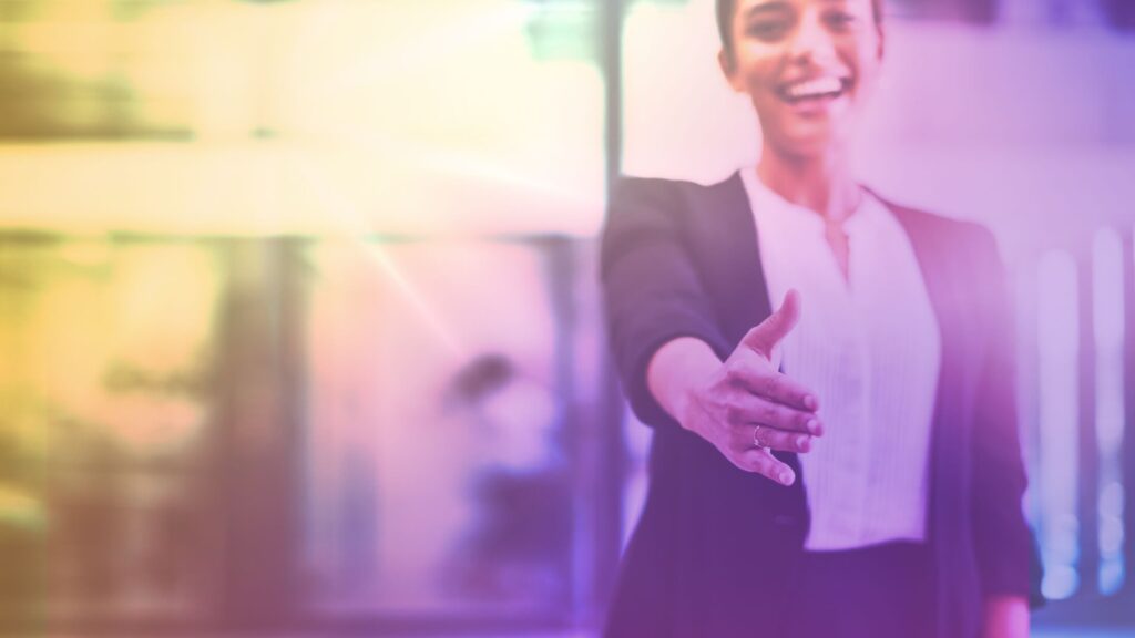 A woman reaching out to shake hands.
