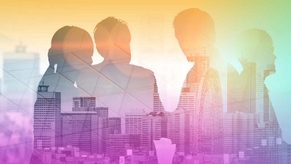A group of people in a city with buildings.
