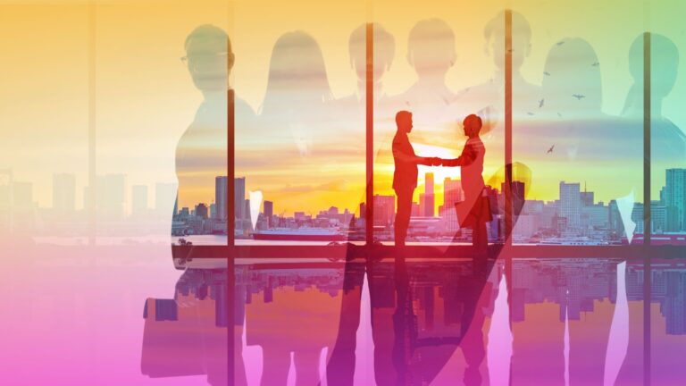 Two people shaking hands in an office with a cityscape in the background.