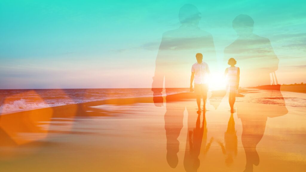 A couple walking along a beach.