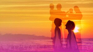 A family by the seaside with a sunset.