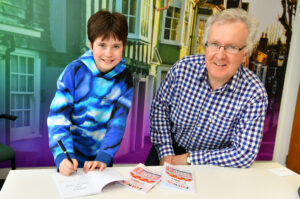 Amy Barnett signing a copy of her book for Family Law Partner Nigel Winter