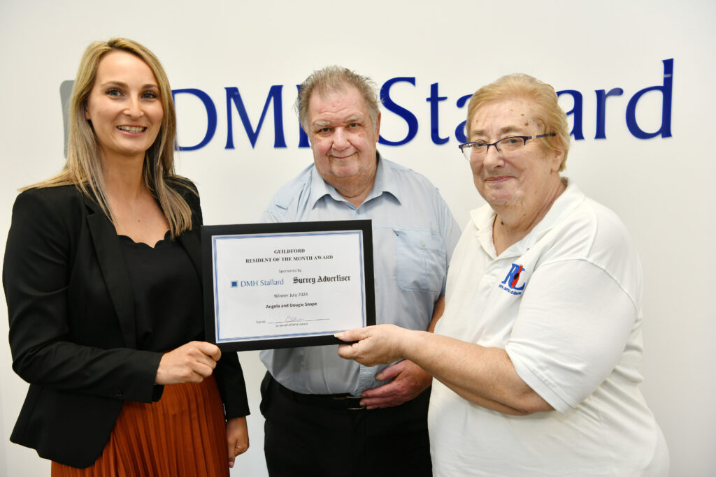 Angela and Dougie Snape receiving the Resident of the Month award For Guildford, September 2024, presented by Cathryn Culverhouse of DMH Stallard