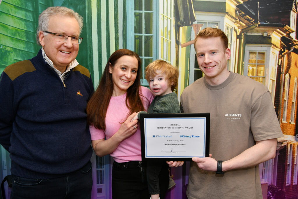 Nigel Winter presenting Holly and Ross Docherty with the Horsham Resident of the Month Award for January 2025