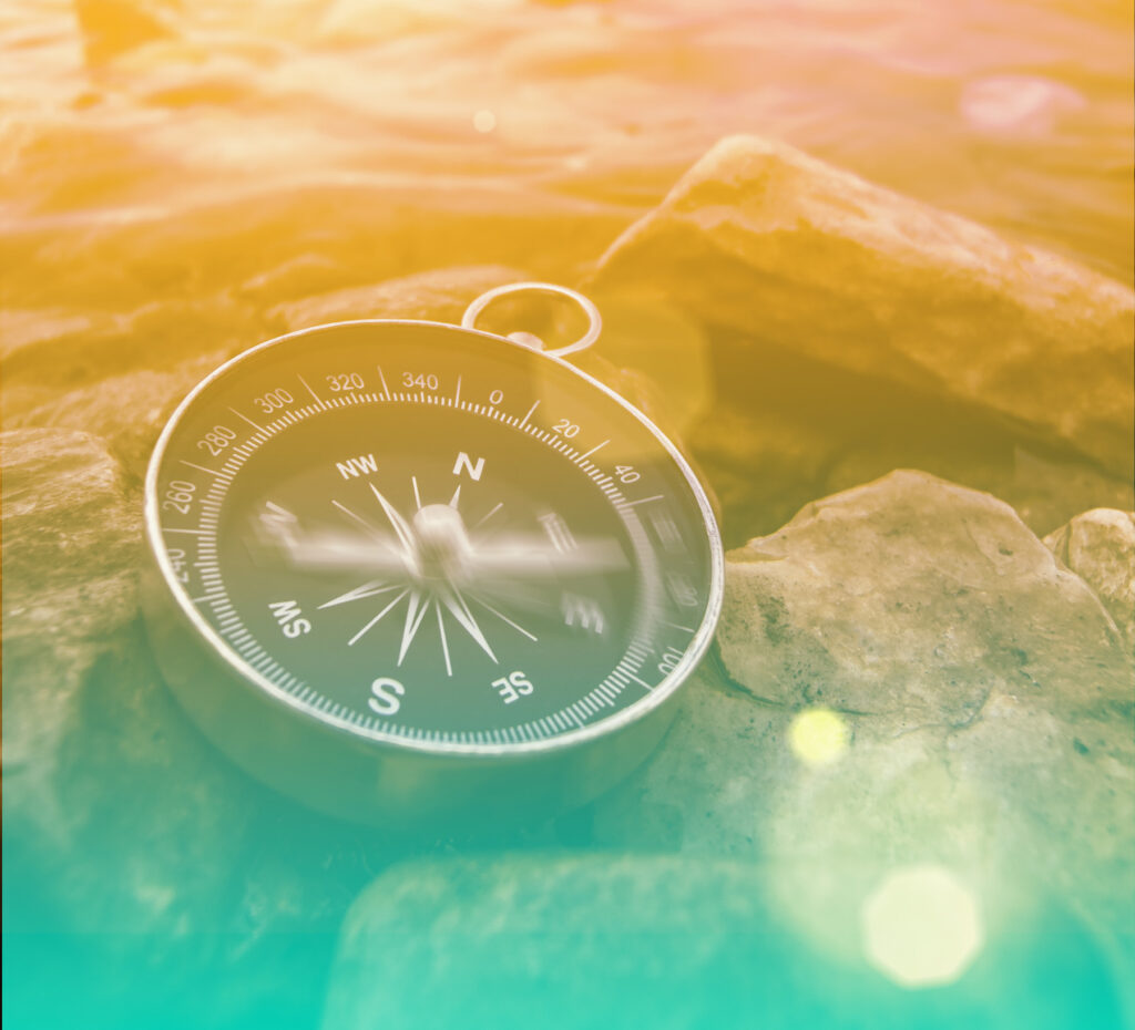 Compass resting on rocks