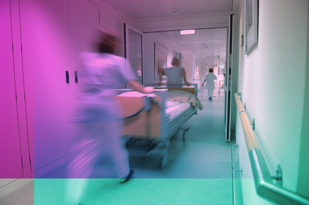 Hospital bed pushed by nurses and doctors
